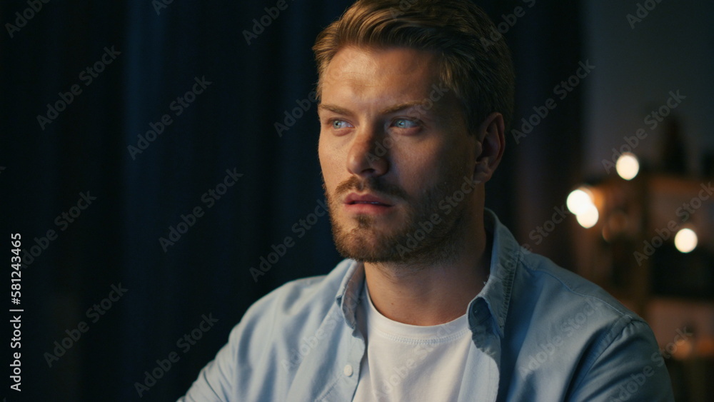 Obraz premium Serious man watching pc at home closeup. Focused freelancer reading computer