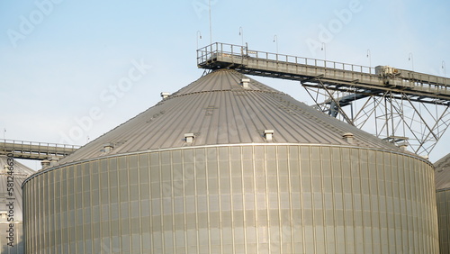 Grain storage. Grain storage elevator. Large metal hangar for grain. Silo with grain