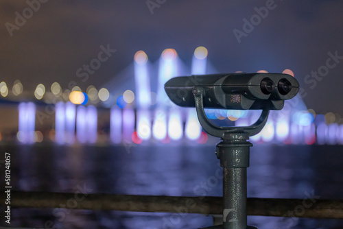 Tarrytown, NY - USA - February 2, 2023: Binoculars at Tarrytown Overlook with the Governor Mario M. Cuomo Bridge and Hudson River in the background.