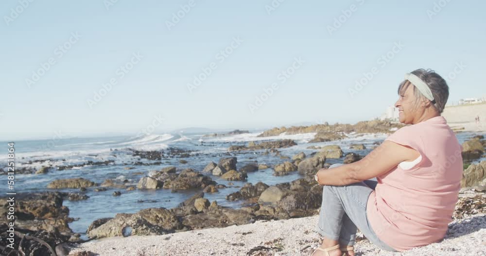 Senior african american woman at beach, copy space, slow motion Senior african american woman at beach, copy space, slow motion