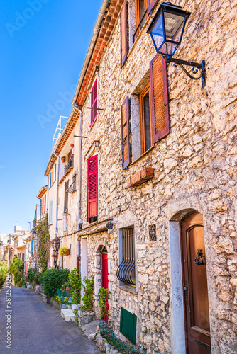 Narrow street with colorful houses in Antibes, Cote d'Azur, France © PhotoFires