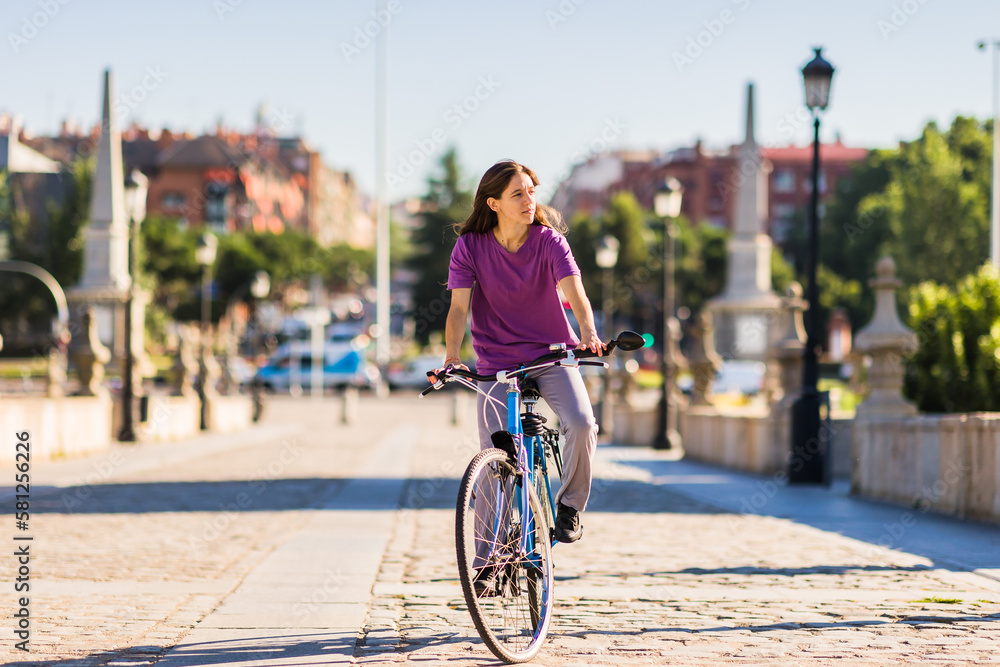 sustainability eco transport lifestyle. uruguayan mid latina woman ride a bike outside in the city
