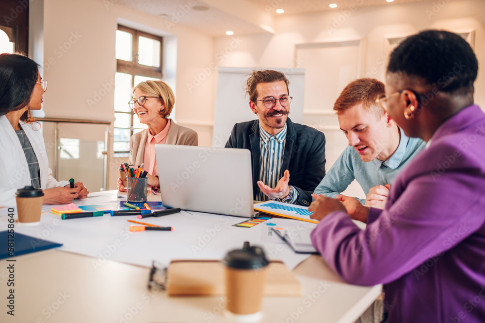 Multiracial business group of people having a meeting in an office Multiracial business group of people having a meeting in an office