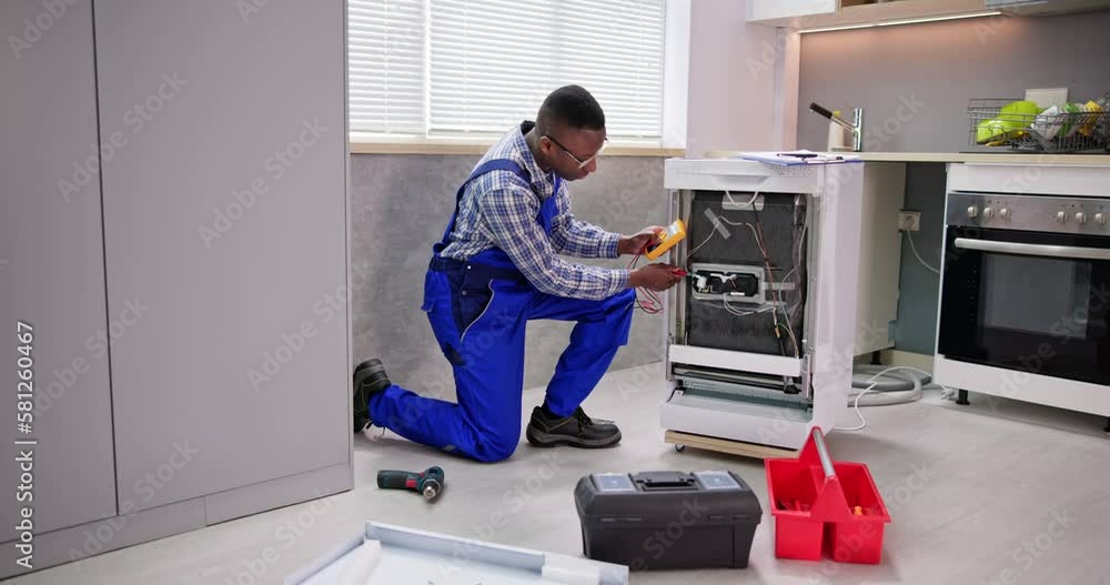 African American Repairman Fixing Dishwasher Appliance African American Repairman Fixing Dishwasher Appliance