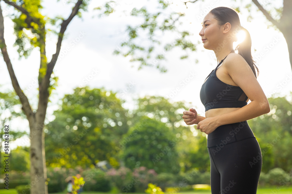 Attractive Asian woman in sportswear jogging exercise at public park in summer morning. Healthy girl athlete enjoy outdoor activity lifestyle sport training fitness running workout in the city. Attractive Asian woman in sportswear jogging exercise at public park in summer morning. Healthy girl athlete enjoy outdoor activity lifestyle sport training fitness running workout in the city.