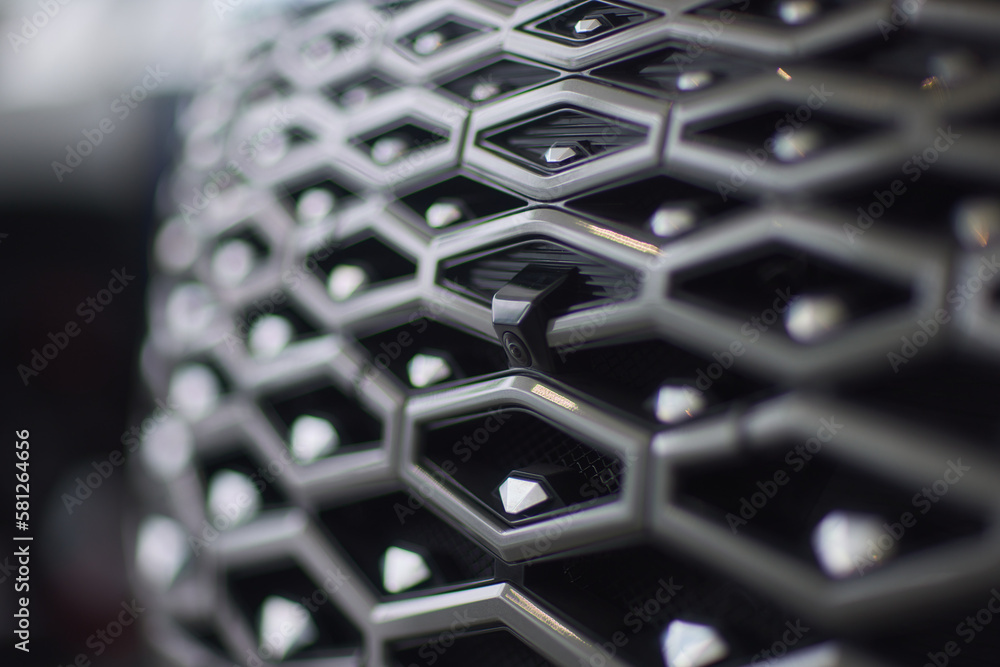 Grid of white sports car. The radiator grille. Metal texture. chrome ...