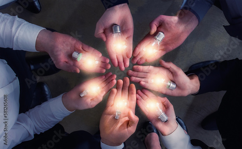 Teamwork and brainstorming concept with businessmen that share an idea with a lamp. Concept of startup