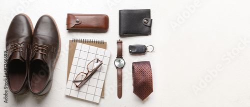 Set of stylish male accessories with notebooks on light background with space for text