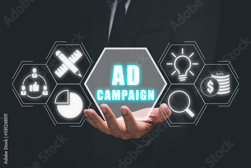 Ad Campaign concept, Business person hand holding ad campaign icon on virtual screen. photo