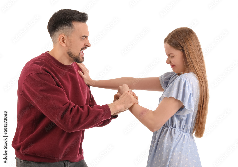 Angry young man hurting his wife on white background. Domestic violence concept Angry young man hurting his wife on white background. Domestic violence concept