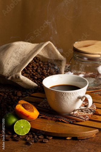 Cup of coffee with beans, lemon and peach