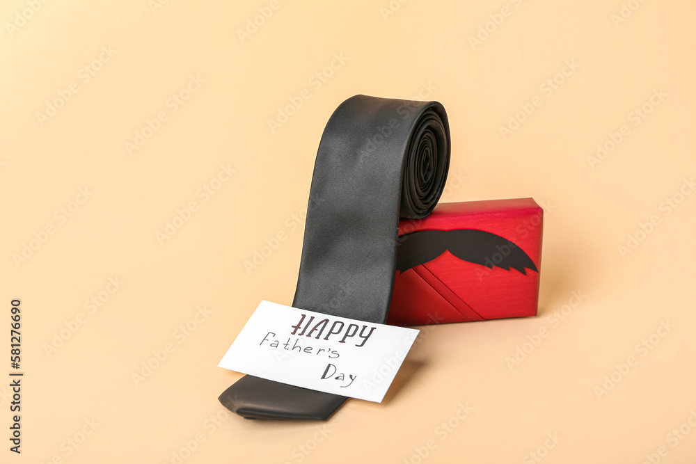 Gift box, tie and card with text HAPPY FATHER'S DAY on color background