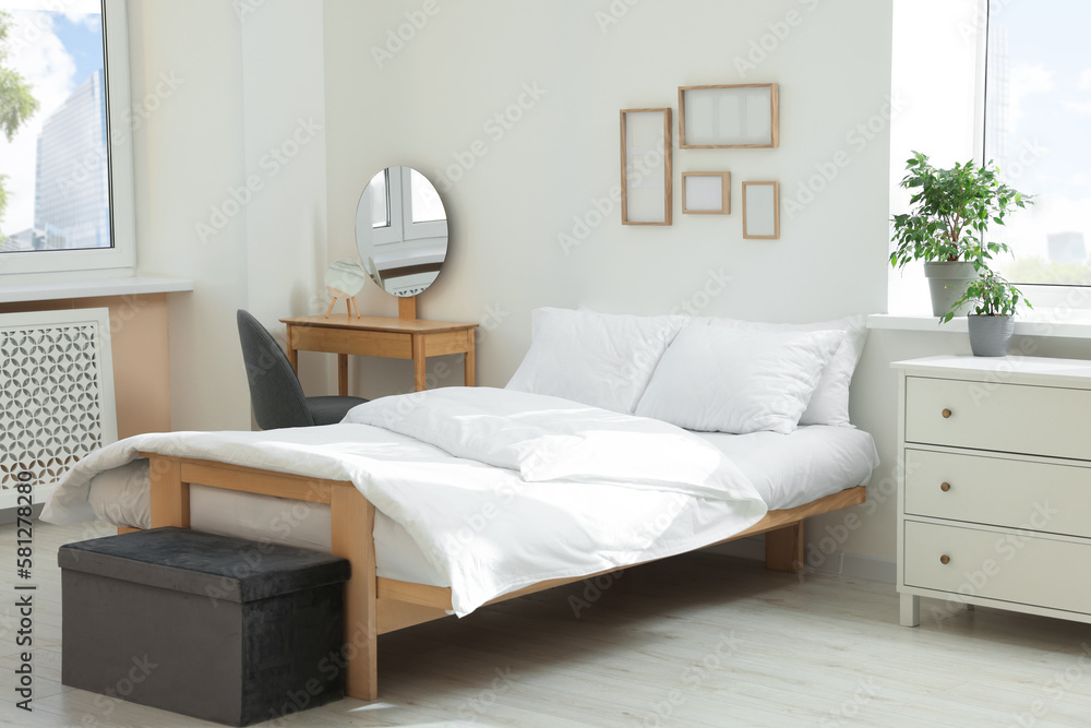 Bed with soft white pillows in cozy room interior Bed with soft white pillows in cozy room interior
