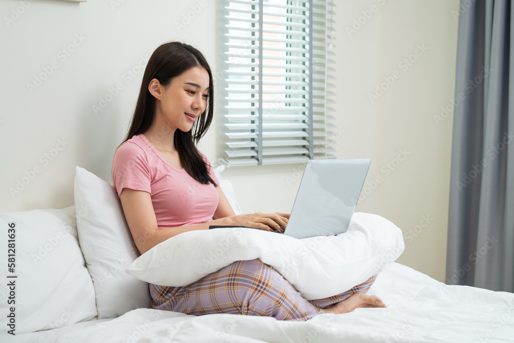 Asian attractive woman using laptop chat on bed at home in the morning. Asian attractive woman using laptop chat on bed at home in the morning.
