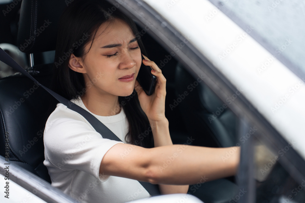 Asian beautiful woman talk on mobile phone while driving on the road. Asian beautiful woman talk on mobile phone while driving on the road.