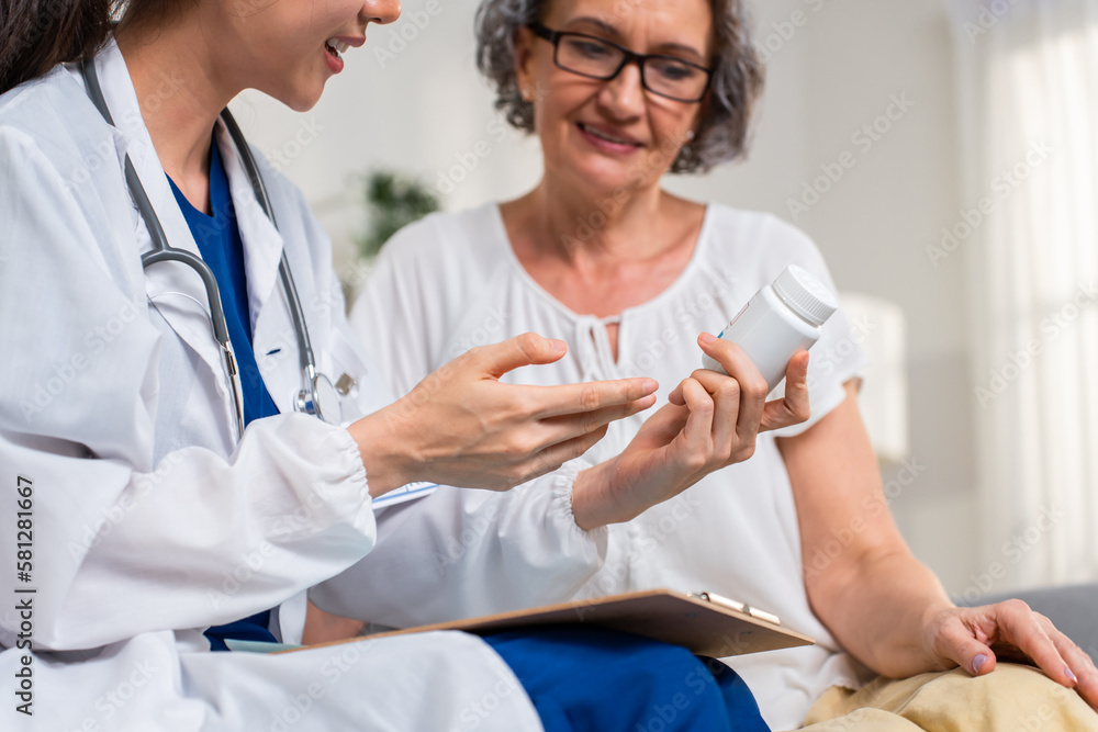 Asian caregiver nurse give consult to Caucasian senior woman patient. Asian caregiver nurse give consult to Caucasian senior woman patient.