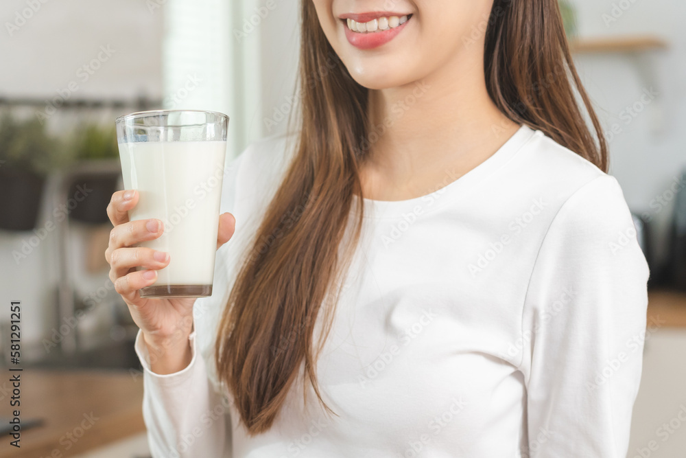 Health care, pretty asian young woman, girl drinking a glass of white fresh, dairy milk for calcium, vitamin wholesome good nutrition in morning at kitchen home. lifestyle, product healthy people. Health care, pretty asian young woman, girl drinking a glass of white fresh, dairy milk for calcium, vitamin wholesome good nutrition in morning at kitchen home. lifestyle, product healthy people.