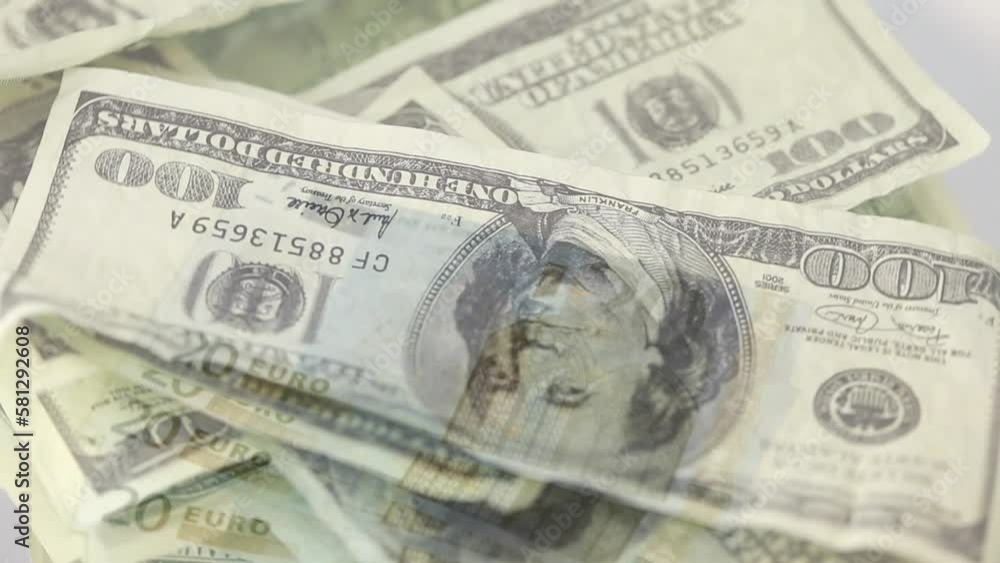 Animation of rotating dollar bills over euros on white table against white background Animation of rotating dollar bills over euros on white table against white background