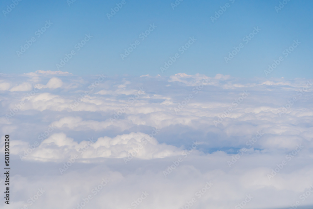 Airplane jet flying above clouds view with blue sky from the window in traveling and transportation concept. Nature landscape background. Airplane jet flying above clouds view with blue sky from the window in traveling and transportation concept. Nature landscape background.