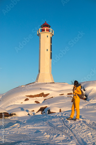 Snowy view of Povorotny lighthouse, Vikhrevoi island, Gulf of Finland, Vyborg bay, Leningrad oblast, Russia, winter sunny day with a blue sky, lighthouses of Russia travel photo