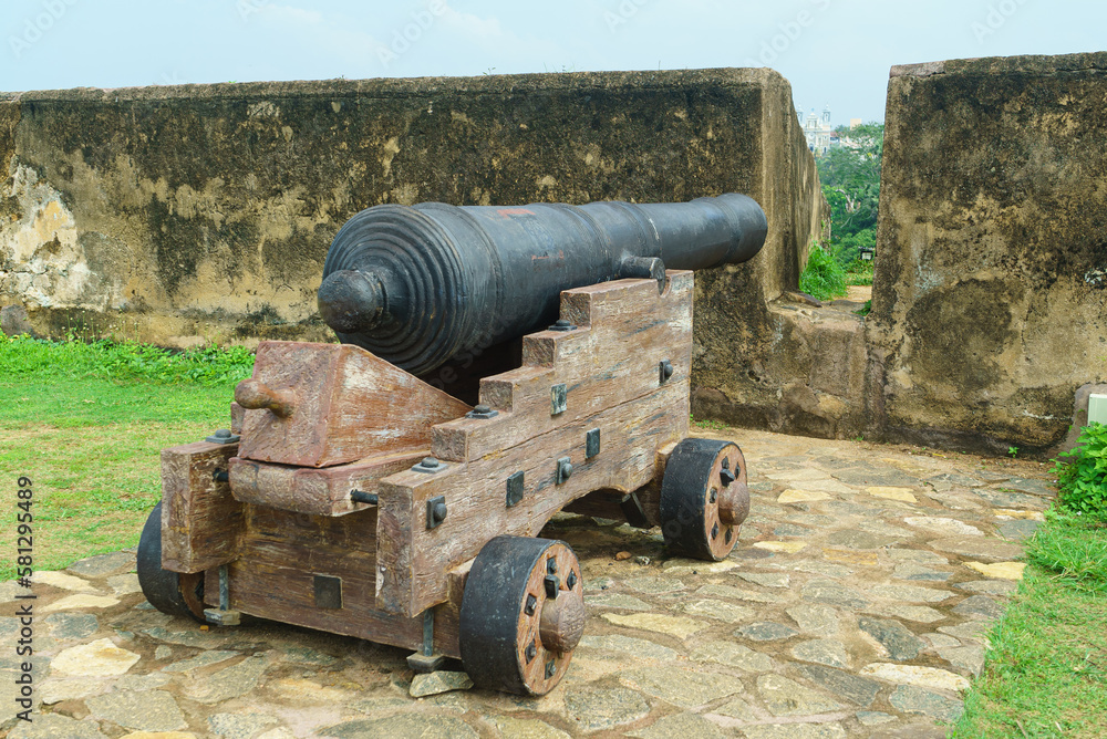 A medieval cannon stands on a fortress