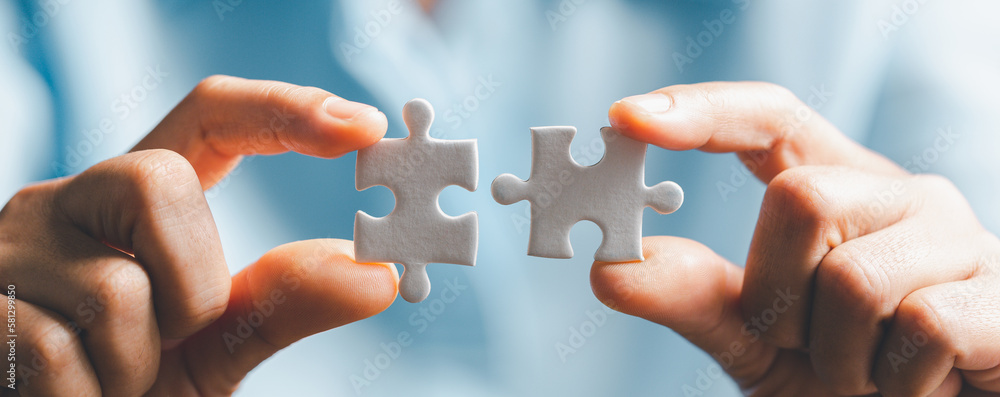 Business woman person hand holding puzzle piece idea for strategy and solution. Closeup part of two white jigsaw connect together. Concept of join cooperation success teamwork-problem corporate team - obrazy, fototapety, plakaty 