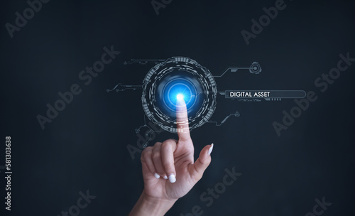 Finger touching some holographic graphic user interface with digital asset technology concepts.