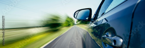 car on the road with motion blur background. Panoramic view with text space