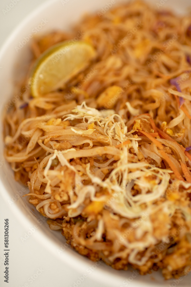 Close Up Photo of White Ceramic Bowl of Tofu Pad Thai with Lime Slice on Kitchen Counter Top Close Up Photo of White Ceramic Bowl of Tofu Pad Thai with Lime Slice on Kitchen Counter Top