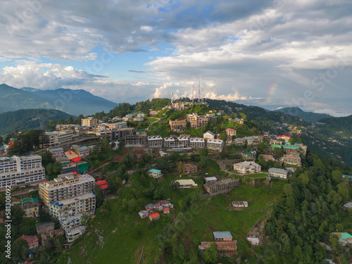 Aerial top view of Muree village, Islamabad with residential local houses and fog mist, nature trees, Pakistan in urban city town in Asia, buildings. photo