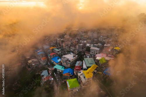 Aerial top view of Muree village, Islamabad with residential local houses and fog mist, nature trees, Pakistan in urban city town in Asia, buildings.