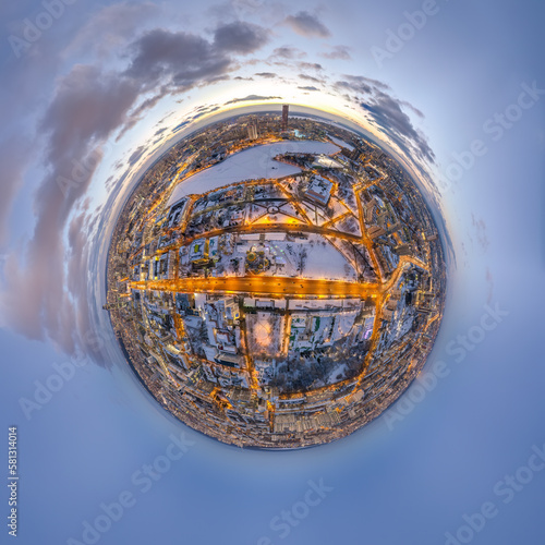 Aerial winter city view with crossroads and roads  houses  buildings  parks and bridges. Copter shot. Little planet sphere mode.
