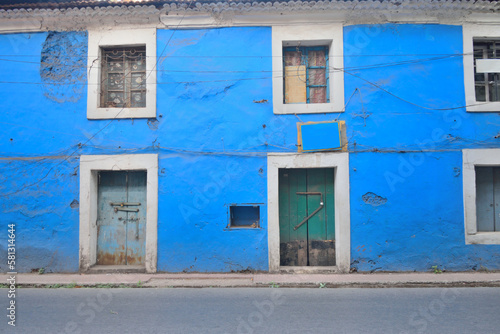 An old, blue coloured Portuguese building in the street in Panaji, Goa.	 photo