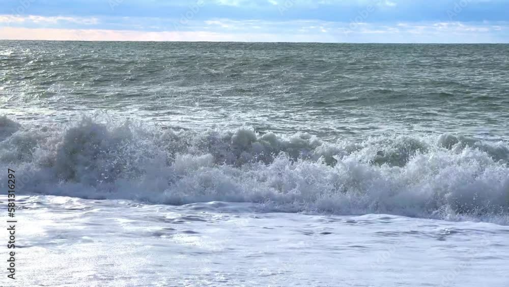 Powerful sea waves are crashing on the Black Sea coast. Waves splash on the beach with pebbles during a storm. Storm at sea. Panoramic view of the Black Sea. Russia. Sunset on the beach. 4K Powerful sea waves are crashing on the Black Sea coast. Waves splash on the beach with pebbles during a storm. Storm at sea. Panoramic view of the Black Sea. Russia. Sunset on the beach. 4K