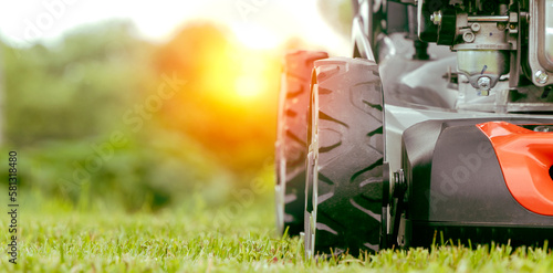 Fotografie lawn mower on a green mown lawn