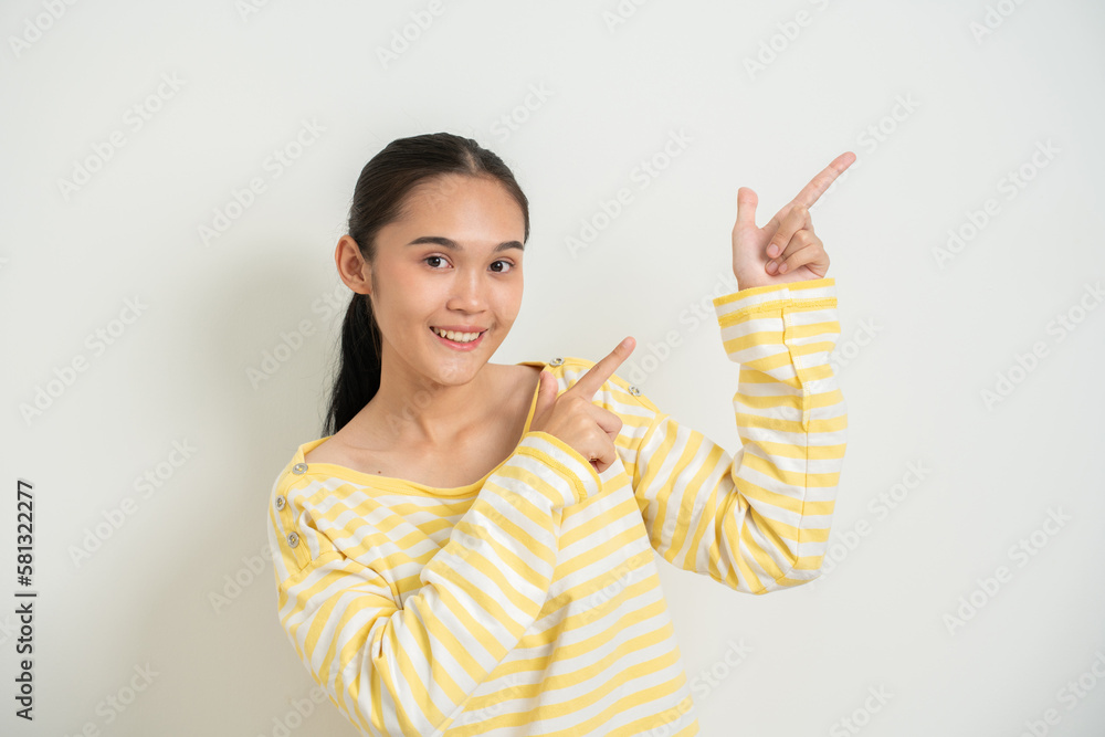 Young Asian girl isolated on white bakcground pointing away Young Asian girl isolated on white bakcground pointing away
