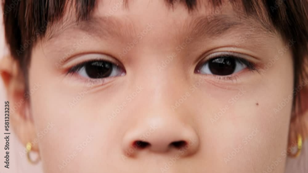 Close-up of beautiful black eyes of a cute little asian girl, wide open black eyes looking at camera. Close-up of beautiful black eyes of a cute little asian girl, wide open black eyes looking at camera.