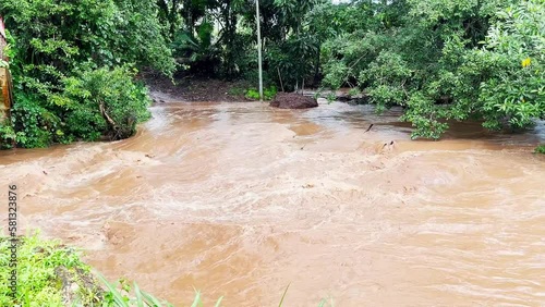 Static shot of the fast turbulent muddy river in the Caimito district, Panama photo
