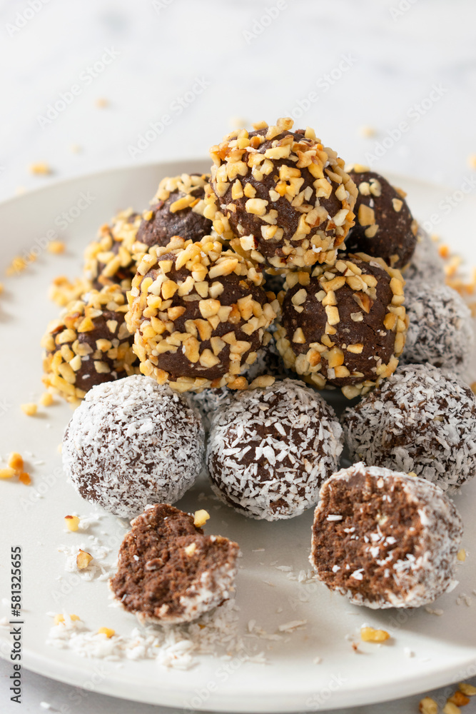 No bake paleo chocolate fat bombs on a white plate. No bake paleo chocolate fat bombs on a white plate.