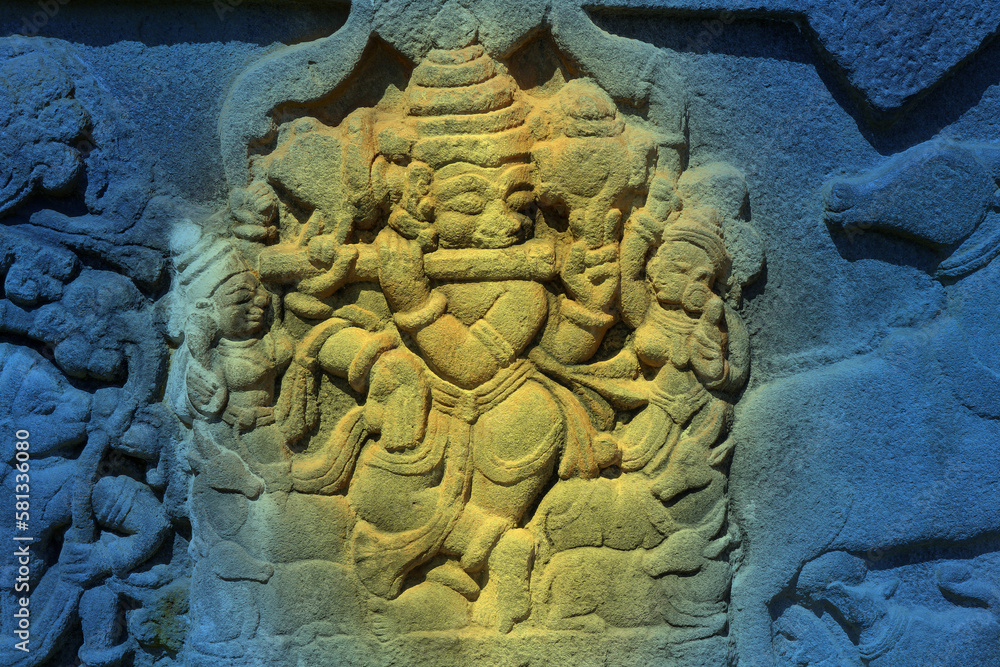 Krishna plays the flute. Fragment of scenery of an ancient Hindu temple.