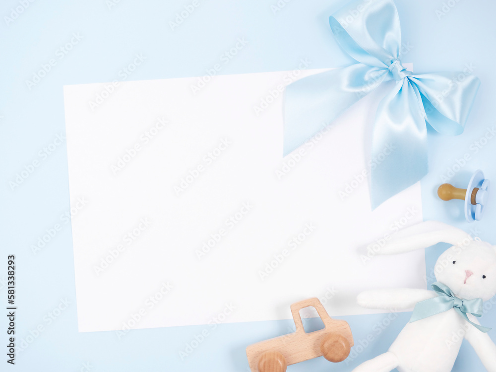 Obraz premium Blue bow, toys, soother on blue background.
