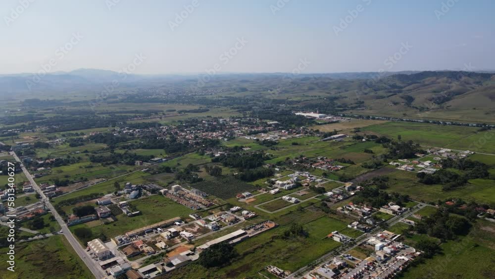 Aerial view of a small town in the countryside with few houses and lots of green space available for housing in the background of mountains on a sunny day in the late afternoon Brazil Porto Real Aerial view of a small town in the countryside with few houses and lots of green space available for housing in the background of mountains on a sunny day in the late afternoon Brazil Porto Real