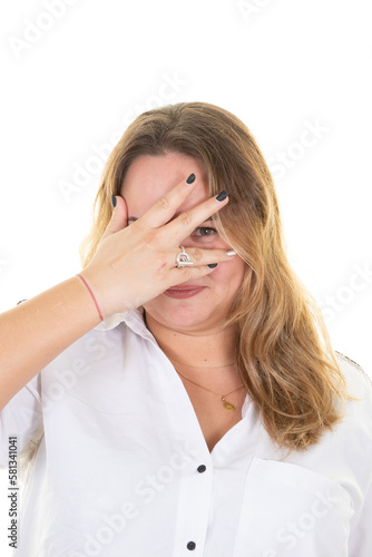 shy blonde woman hides eyes and hand gaze young chubby hiding behind palm portrait on white background studio shot © OceanProd