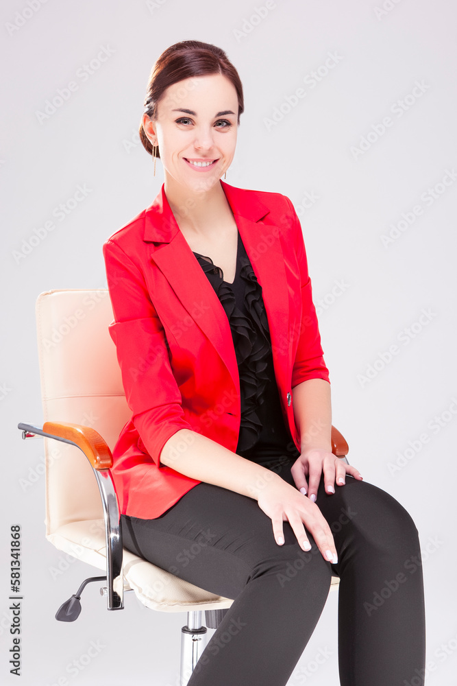 Women in Business. Portrait of Winsome Business Woman With Smile and red Suit jacket Posing Against White. Women in Business. Portrait of Winsome Business Woman With Smile and red Suit jacket Posing Against White.