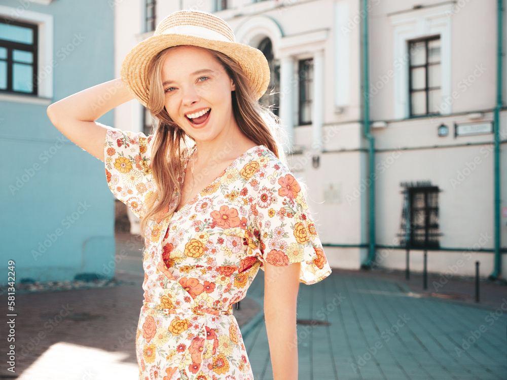 Beautiful smiling brunette model. Trendy female posing in the street background. Funny and positive woman having fun outdoors at sunset. In hat at sunny day. In dress. Cheerful and happy