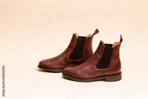 Footwear ideas. Pair of Classic Leather Chealsea Boots As Still Life Concepts Placed Over One Another