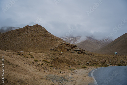 Beautiful view mountain and street view of Khardung La Pass- Leh road on the high mountain covered with snow. It is the highest pass in the world that motorbikes can run through at Ladakh, Leh, India