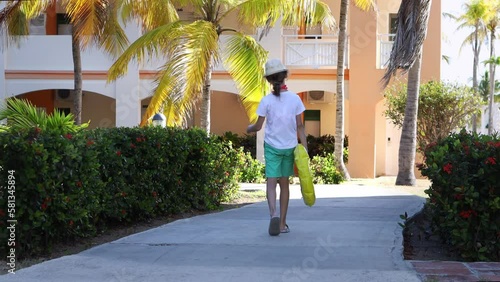 Children relax at the hotel on a hot sunny day.A boy and a girl came for the summer holidays.The kids are going to go to the beach.Weekend at the sea.The concept of family, freedom and travel