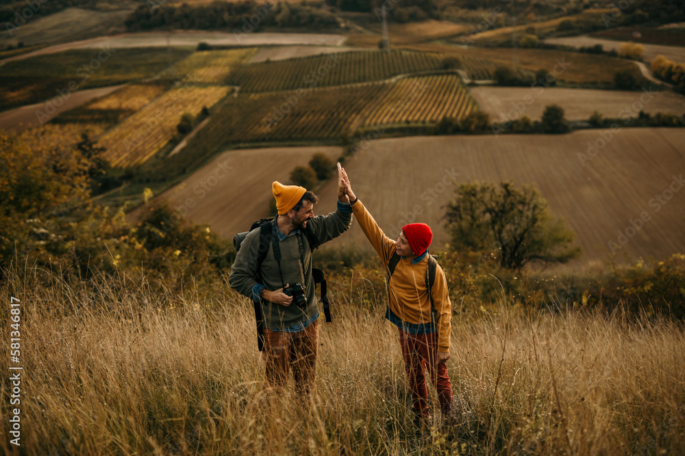 Father with son trekking in mountains during a weekend vacation. Achievement concept Father with son trekking in mountains during a weekend vacation. Achievement concept