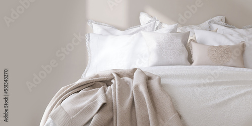 Tableau sur toile Close up of bed with lacework cover sheet, white and brown embroidered pillowcas